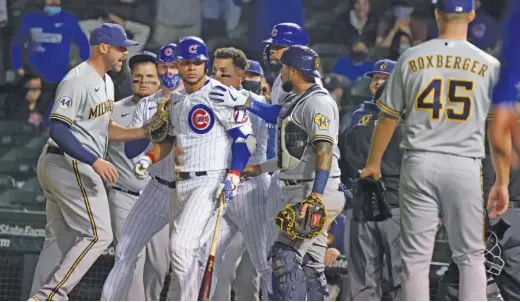 ?? NUCCIO DINUZZO/GETTY IMAGES ?? Willson Contreras stares down Brewers reliever Brad Boxberger after he was hit by a pitch in the ninth inning. The benches cleared briefly.