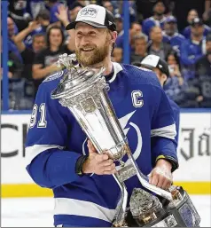  ?? CHRIS O’MEARA/AP ?? Steven Stamkos (with the Prince of Wales Trophy after the clincher against the Rangers in the East finals) and his Tampa Bay teammates are trying to become the first team to win three titles in a row since 1983.