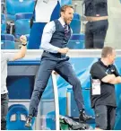  ??  ?? Jumping for joy: Gareth Southgate celebrates the winner against Tunisia