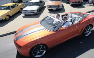  ?? PHOTO: BLOOMBERG ?? Rick Wagoner, chief executive of General Motors, drives the new Chevy Camero along Detroit’s Woodward Avenue during the annual Dream Cruise which is the largest event of its kind. But GM banks on driverless cars for the future.