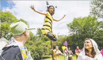  ?? MATT SMITH ?? Micheal Martin, left, and Mara Teare, right, listen to a bee played by Megan Zong in last summer’s Sum Theatre’s production of the Young Ones. COVID-19 has forced the group to change formats this year.