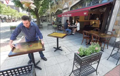  ?? Matthew Brown / Hearst Connecticu­t Media ?? Owner Alain Bars of Chez Vous Bistro on Bedford Street sets up his extended outdoor dining area on May 30 in Stamford.