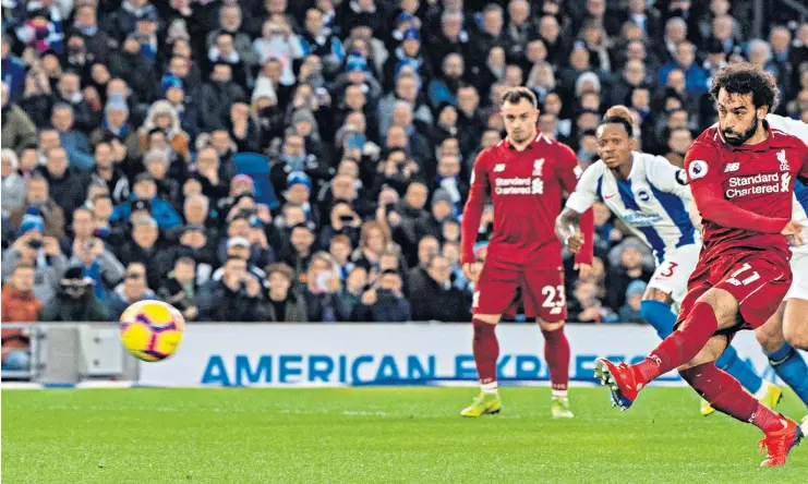  ??  ?? Reds reboot: Mohamed Salah nets his penalty winner for Liverpool and (right) is congratula­ted by Jordan Henderson