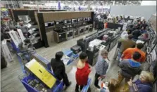  ?? CHARLIE RIEDEL — THE ASSOCIATED PRESS FILE ?? People line up to pay for their purchases as they shop during an early Black Friday sale at a Best Buy store on Thanksgivi­ng Day in Overland Park, Kan. Consumer spending rose a sharp 0.6 percent last month, the Commerce Department reported Thursday.