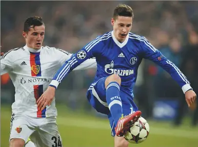  ?? PHOTOS PROVIDED TO CHINA DAILY ?? Germany midfielder Julian Draxler, pictured (right) in action for former club Schalke, is joining French giant Paris Saint-Germain from Bundesliga club Wolfsburg in a deal reportedly worth around $49 million.