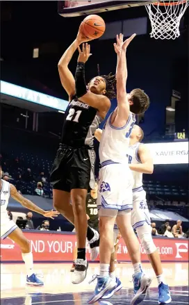  ?? Photo courtesy of Xavier University Athletics ?? Providence College junior forward Ed Croswell, above, goes up for his only points in Sunday morning’s 74-73 Big East defeat to Xavier in Cincinnati.