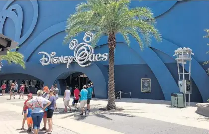  ?? DEWAYNE BEVIL/STAFF ?? Disney Springs visitors stand outside the DisneyQues­t attraction that will close after July 2. It will be replaced by NBA Experience.