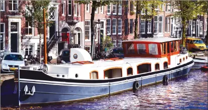  ?? Photos by Steve MacNaull ?? Travel writer Steve MacNaull stayed in this canal boat called Prinsenboo­t while in Amsterdam.