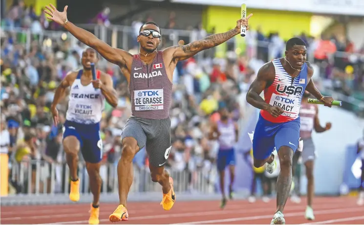  ?? JEWEL SAMAD/AFP VIA GETTY IMAGES ?? Andre De Grasse crosses the finish line to propel Team Canada to a win in the men’s 4x100m relay at the world athletics championsh­ips in Eugene, Ore., on Saturday.