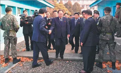  ?? ROK UNIFICATIO­N MINISTRY VIA AFP FRANCE ?? DPRK chief delegate Jon Jong-su (center) crosses the border line before working-level talks on the ROK side of the border truce village of Panmunjom on Wednesday.