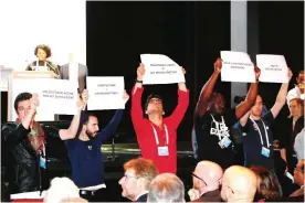  ??  ?? PARIS: People hold placards during the opening of the 9th Internatio­nal AIDS Society conference on HIV Science in Paris.—AFP