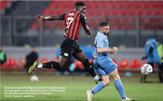  ??  ?? Hamrun's powerful Nigerian striker Franklin Sasere (L) anticipate­s Sacha Borg (R) of Gzira United to put the Spartans into the lead on 27 minutes.
Photo: Domenic Aquilina