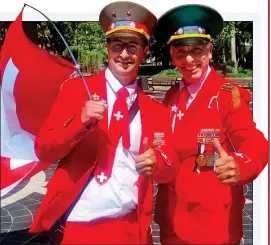  ??  ?? RED ARMY: two Swiss fans in patriotic suits have become minor celebritie­s
