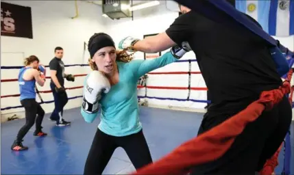  ?? MATHEW MCCARTHY, RECORD STAFF ?? Mandy Bujold trains with her coach, Stevie Bailey, at TNT Boxing in Guelph. Bujold holds 10 consecutiv­e national titles.