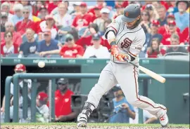  ?? ALEX BRANDON — THE ASSOCIATED PRESS ?? The Giants’ Brandon Crawford bears down on a pitch from Nationals ace Max Scherzer, hitting it for a two-run home run during the fourth inning Sunday at Nationals Park.