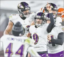  ?? Ron Schwane The Associated Press ?? Justin Tucker (9) is mobbed by teammates after drilling a 55-yard field goal with two seconds left that helped the Ravens beat the Browns.