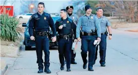  ??  ?? Oklahoma City police officers Billy Robison, left, Eric Gengnagel, Capt. Melvin Davis, Joshua Gershon and Capt. Bill Patten were knocking on doors and talking to citizens about concerns in their neighborho­od in northeast Oklahoma City.