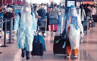  ?? PHOTO: DALIP KUMAR ?? Passengers in protective gear at Delhi Internatio­nal Airport on Monday