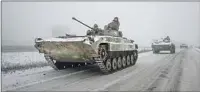  ?? Yasuyoshi Chiba AFP/Getty Images ?? UKRAINIAN BMP-2 infantry combat vehicles in January.