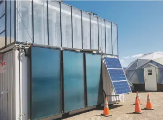  ??  ?? Mike Straights’s FarmPod grows food at its new home in front of the geodesic dome greenhouse behind the Trades and Advanced Technology Center at Santa Fe Community College. Below, Olga Ascoli and Billy Roop, students of aquaponics at SFCC, say one of...