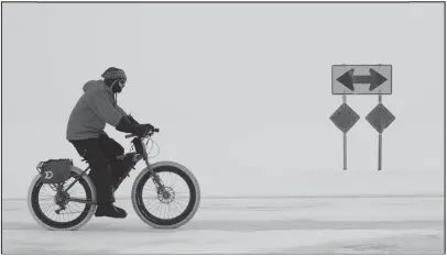  ?? Photo by Nils Hahn ?? BIKER— David Ojanen took his fat tire bike for a spin down the Nome-Council Highway on Friday, February 24.