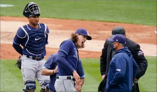  ?? AP Photo/Frank Franklin II ?? Tampa Bay Rays starting pitcher Tyler Glasnow reacts to pain as a trainer helps him during the fifth inning of a baseball game against the New York Yankees as catcher Francisco Mejia (left) watches on Saturday in New York.