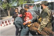  ?? Andrew Quilty / New York Times ?? A man injured in the May 31 Kabul truck bombing that killed over 150 is carried to an ambulance.