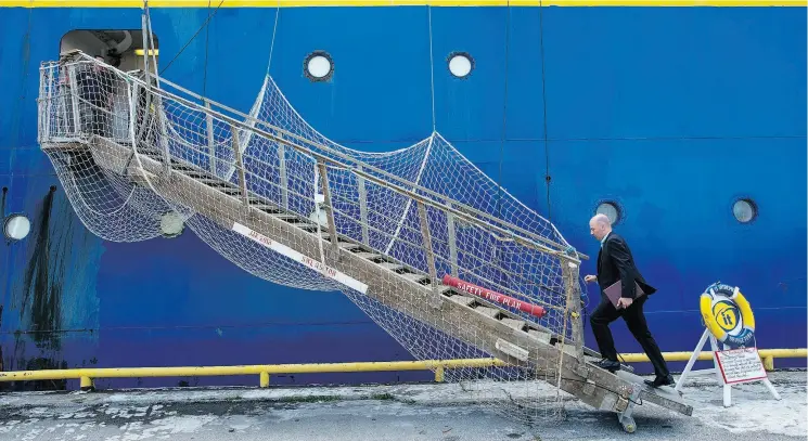  ?? TYLER ANDERSON / NATIONAL POST FILES ?? Crosslake Fibre CEO Mike Cunningham boards the C.S. IT Intrepid, a cable ship which will be installing a submarine fibre-optic cable across Lake Ontario from Toronto to New York.