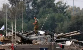  ?? ?? An Israeli soldier works atop a tank outside the border with Gaza. Plans to send some reservists home mark the start of a new stage in the war. Photograph: Amir Cohen/Reuters