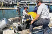  ?? PETER KROUSE / CLEVELAND.COM ?? Employees of LimnoTech prepare to have a smart buoy taken into Lake Erie and placed near a Cleveland Water intake near Euclid.