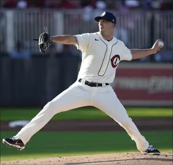  ?? PHOTOS BY CHARLIE NEIBERGALL – THE ASSOCIATED PRESS ?? Cubs starter Drew Smyly pitched five shutout innings to beat the Reds in Thursday night’s “Field of Dreams” game.
