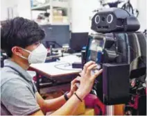  ??  ?? Thai hospitals are deploying ‘ninja’ robots to measure fevers and protect the health of overburden­ed medical workers on the frontlines. – AFP