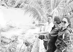  ??  ?? Peter, Jenifer and Luvita inspecting the badly damaged hanging bridge at Kampung Kambau.