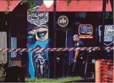  ?? AFP PIC ?? An officer walking past the GLHF Game Bar in Jacksonvil­le, Florida, on Monday.