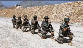  ?? THOMAS GIBBONS-NEFF / WASHINGTON POST ?? Afghan commandos-in-training line up for ammunition at a training range south of Kabul this week.