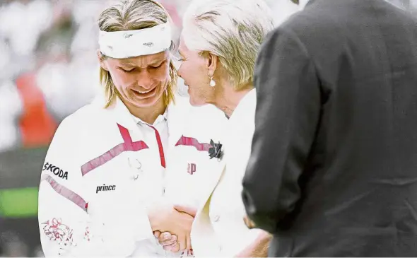  ??  ?? Holding back the tears: In this July 3, 1993 file photo, Jana Novotna breaks down and weeps as she accepts the loser’s plate from the Duchess of Kent, after the women’s singles final at Wimbledon. — AP