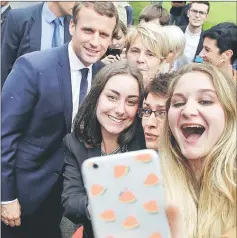  ??  ?? Students take a selfie photo with Macron (rear left) during his visit to the Vaseix agricultur­al college in Verneuil-sur-Vienne, France as part of a two-day visit in the Haute-Vienne department. — Reuters photo