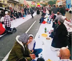  ?? PICTURE: SUPPLIED ?? COMMUNITY SPIRIT: Bo-Kaap residents break their fast together in the streets of their neighbourh­ood.