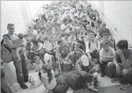  ?? Sean Gallup Getty Images ?? MIGRANTS are held at a Rosenheim, Germany, train station before being registered. The nation is opening its arms to more refugees than any other in Europe.