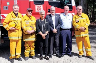  ??  ?? Victorian Governor Linda Dessau (centre) and her husband Anthony Howard met with members of the Drouin West CFA who were in a now famous photograph of a tanker escaping the Bunyip Ridge fire on Black Saturday including (from left) Ian Maxfield, Reg Murrill, Gary Cheesman and Bruce Jewell.