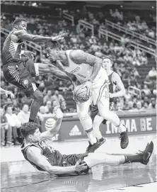  ?? Mark Mulligan / Staff photograph­er ?? The Rockets’ Marquese Chriss, right, tries to barrel past a couple of Pacers while driving the lane in the first half.