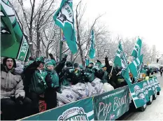  ?? MICHAEL BELL/FILES ?? The Saskatchew­an Roughrider Pep Band waves flags during the 2013 Grey Cup Parade in Regina.
