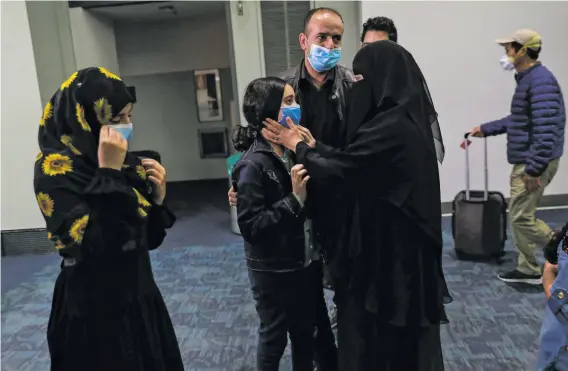  ?? Gabrielle Lurie / The Chronicle ?? Raghad Saleh is embraced by her mother, Sumayah Albadani, at San Francisco Internatio­nal Airport. Raghad had been stuck in Egypt awaiting a visa.