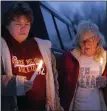  ?? ASHLEY MILLER — FOR THE MORNING SUN, FILE ?? In this photo from 2011, Rose Litwiller, left, and Barb Sanford stares on during the opening prayers of Glenn Hustin’s candleligh­t vigil service Saturday night in Perrinton. Glenn, Litwiller and Sanford’s step-brother and son accordingl­y, who had been missing for 10 years.