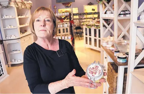  ?? STEPHEN MONTOYA/JOURNAL ?? Sharon Gateley, founder of LaVon Blu, a cosmetic and beauty supply shop in Nob Hill, holds one of her own homemade face creams.