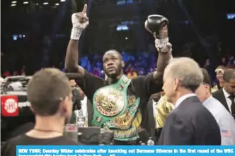  ??  ?? NEW YORK: Deontay Wilder celebrates after knocking out Bermane Stiverne in the first round of the WBC heavyweigh­t title boxing bout, in New York. — AP