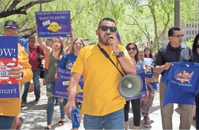  ?? MARK HENLE/THE REPUBLIC ?? Oscar Aragon leads a protest against Walmart to the Phoenix Police Department in downtown Phoenix on Monday.