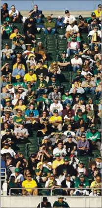  ?? NHAT V. MEYER — STAFF PHOTOGRAPH­ER ?? Fans watch the Athletics at the Coliseum in pre-pandemic 2019, when there were no restrictio­ns. This season the A’s and Giants are on track to host up to 20% capacity at their first home games.