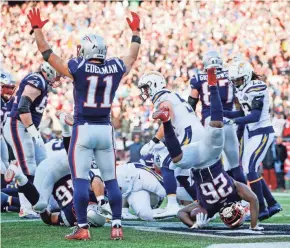  ?? DAVID BUTLER II/USA TODAY ?? New England’s Julian Edelman celebrates as running back Sony Michel dives in for a touchdown during the second quarter.