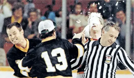  ?? POSTMEDIA NETWORK FILES ?? Tim Shea of the Flying Fathers takes a pie in the face from team manager Grant Neville during a past charity game by the Flying Fathers, a team of hockeyplay­ing priests formed in 1963.